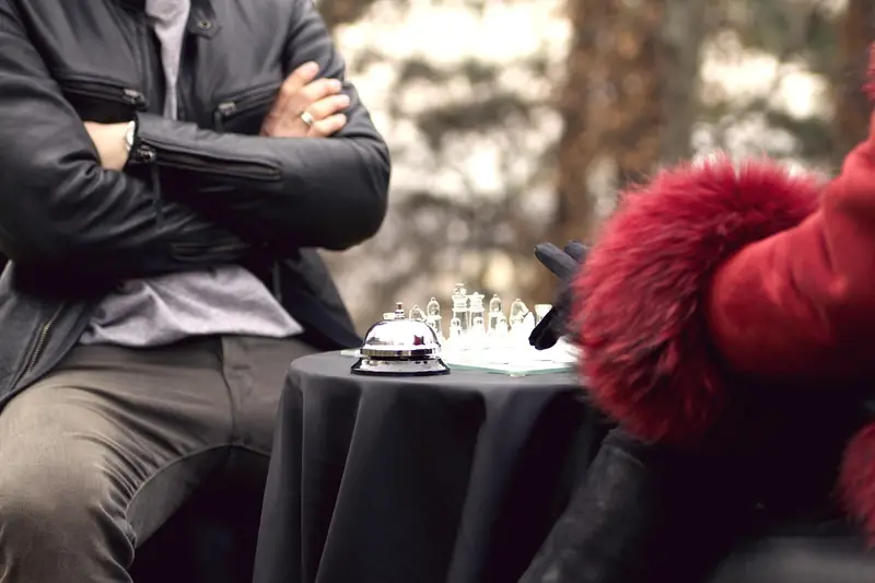 An outdoor game of chess in a sunlit park, evoking a warm, community chess scene.
